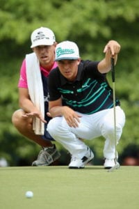 PINEHURST, NC - JUNE 13: Rickie Fowler of the United States and caddie Joseph Skovron line up a putt on the sixth hole during the second round of the 114th U.S. Open at Pinehurst Resort & Country Club, Course No. 2 on June 13, 2014 in Pinehurst, North Carolina. (Photo by Andrew Redington/Getty Images)