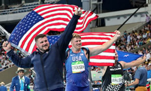 From left, silver medalist for the men's shot put United States' Joe Kovacs, gold medallist and compatriot Ryan Crouser and New Zealand's Tomas Walsh, bronze, celebrate with their national flags during the athletics competitions of the 2016 Summer Olympics at the Olympic stadium in Rio de Janeiro, Brazil, Thursday, Aug. 18, 2016. (AP Photo/Lee Jin-man)